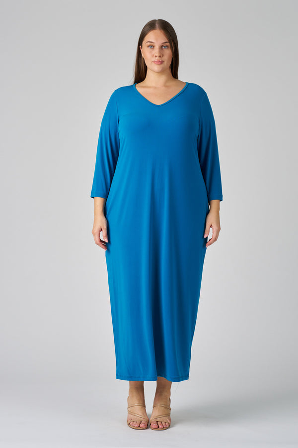 Woman wearing a blue dress on a gray background